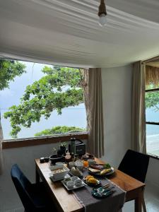 a dining room table with plates of food on it at Sea for Rest beach club 