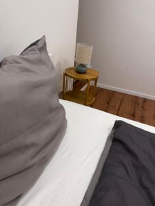 a bedroom with a bed and a table with a chair at Luxury Apartment nähe Düsseldorf in Wuppertal