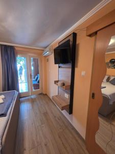 a room with a bed and a tv in a room at VILLA Bose in Brela