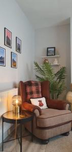a living room with a brown couch and a table at Ample town house in Workington, West Lakes, Lake District in Workington