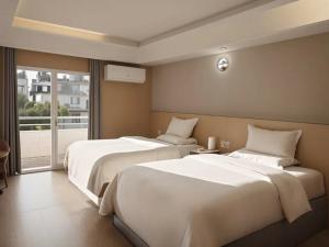 a hotel room with two beds and a window at Star Valley Hotel in Kathmandu +41 photos
