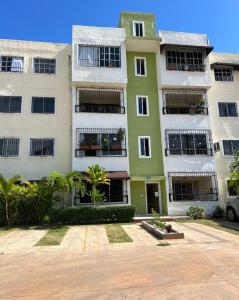 a green and white apartment building with a parking lot at Casaharmonia in San Isidro