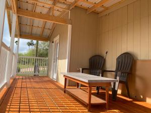 a screened porch with a table and two chairs at Country Home close to Town in Harlingen