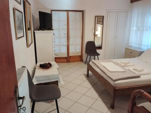 a room with a bed and a table and chairs at Dimitra's traditional house in Katarráktis
