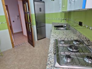 a kitchen with a stove and a sink at Appartment Mirador Al Hoceima in Al Hoceïma
