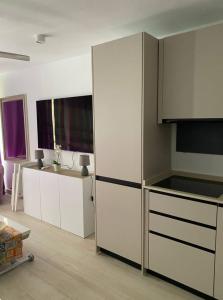 a kitchen with white cabinets and a counter top at 7 building Aloe - Lovely Apartment, Wifi gratis Central near dunes G in Maspalomas