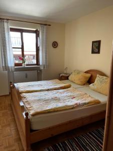 two beds in a bedroom with a window at FeWo Feil nord in Freilassing