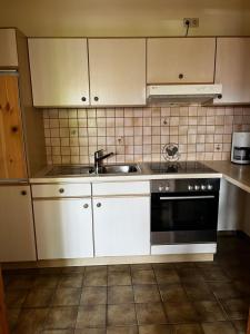 a kitchen with a sink and a stove at FeWo Feil nord in Freilassing