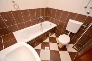 a bathroom with a toilet and a sink and a tub and a toilet at Apartments Panorama in Kotor +44 photos