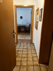 a hallway with a door and a table in a room at FeWo Feil süd in Freilassing