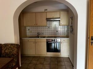 a kitchen with a sink and a stove at FeWo Feil süd in Freilassing