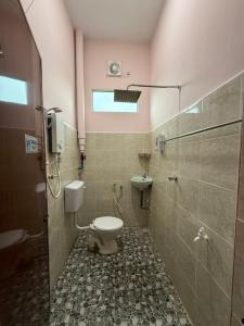 a bathroom with a toilet and a sink at Bilik Inap Sofya in Bachok