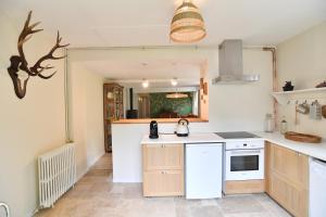 a kitchen with a sink and a stove at La Maison Forestière in Lyons-la-Forêt +4 photos