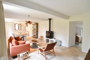 a living room with a couch and a fireplace at La Maison Forestière in Lyons-la-Forêt