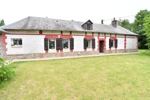 an old brick house with a grass yard at La Maison Forestière in Lyons-la-Forêt
