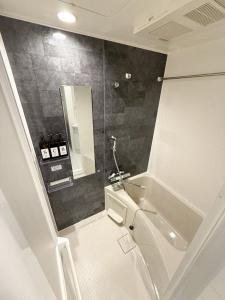 a bathroom with a toilet and a sink and a mirror at Palace Yokohama New & Private in Yokohama +17 photos