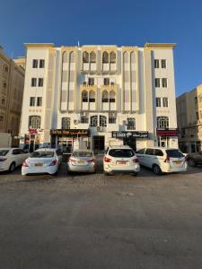 a group of cars parked in front of a building at Ruslan in Muscat