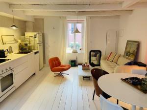 a kitchen and living room with a couch and a table at Maison Solar Trentemoult in Rezé