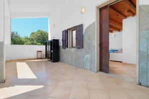 a large room with a stone wall and a doorway at Villa Marianna - Almiddina in Telti