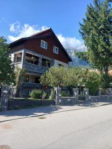 a large house with a fence in front of it at Casa Bogdan in Buşteni