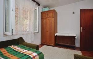 a living room with a couch and a cabinet and a window at Apartment Natasa in Splitska