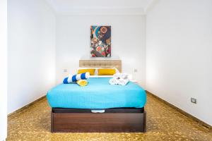 a bedroom with a blue bed in a room at Lunin Apartments in Las Palmas de Gran Canaria