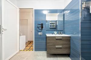 a bathroom with a sink and a shower at Lunin Apartments in Las Palmas de Gran Canaria +109 photos
