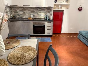 a kitchen with a table and a red refrigerator at Casa Paola in Pontremoli