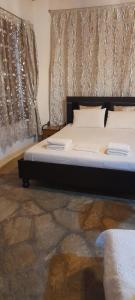 a bedroom with a bed with two monitors on it at Γοργονα in Voutás