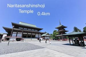 a large building with people walking in front of it at 幸Happiness 10 Guests Near Narita temple park&Narita Airport 3 Parking Spaces Spacious Home in Narita
