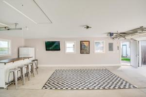 a white room with a black and white rug on the floor at 3 Mi to Road America Spacious Elkhart Lake Home! in Elkhart Lake