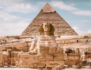a lion statue in front of the pyramid at The GEM Star House in Cairo