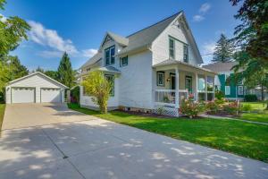 a white house with a driveway at 3 Mi to Road America Spacious Elkhart Lake Home! in Elkhart Lake