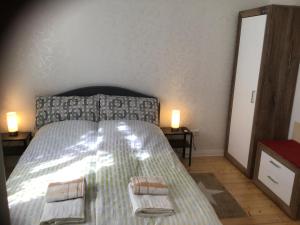 a bedroom with a bed with two towels on it at Gästehaus Schinna in Stolzenau