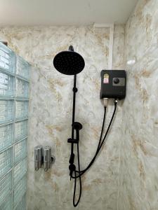 a shower in a bathroom with a shower head at เขาลมเย็น in Khao Kho