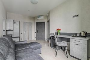 a kitchen and living room with a couch and a table at Green Line in Kyiv