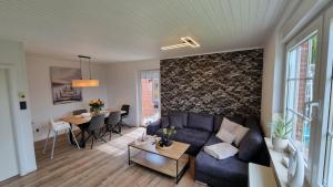 a living room with a couch and a table at Ferienhaus Friesenengel in Dornumersiel