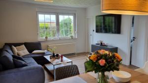 a living room with a couch and a table at Ferienhaus Friesenengel in Dornumersiel