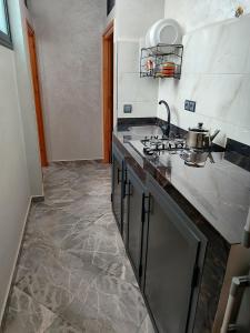 a kitchen with a sink and a counter top at Sea Breeze 4 in Imsouane +7 photos