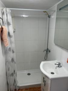a white bathroom with a shower and a sink at Apartment Málaga Airport in Cártama