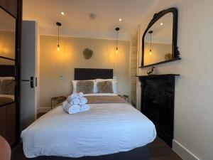 a bedroom with a large white bed with a mirror at Luxury double bedroom en suite in London +24 photos