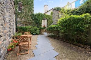 a garden with a stone walkway next to a building at two bed Seafront apartment - sea views in Aberystwyth