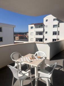 a table and chairs on a balcony with a building at Casa Angela in Olbia