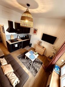 a living room with a couch and a table at Little Corsaire Gare parking & bus in Saint Malo