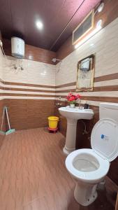 a bathroom with a toilet and a sink at The Moonlight Stay Kasauli in Kasauli +24 photos