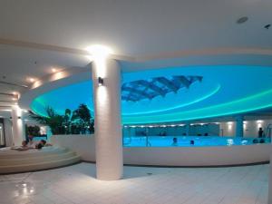 a large building with a swimming pool at night at Apartament Hanza Tower 13th floor with balcony in Szczecin