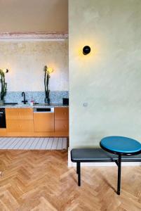 a kitchen with a blue table and a sink at Sky & Sea - Ramsgate in Ramsgate