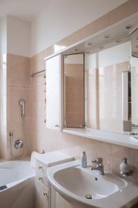 a bathroom with a sink and a tub and a mirror at Apartment Perwanger in Appiano sulla Strada del Vino +16 photos
