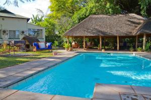 a swimming pool with a gazebo at Mose St in Livingstone
