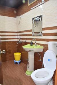 a bathroom with a toilet and a sink at The Moonlight Stay Kasauli in Kasauli